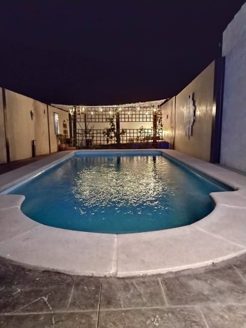 Pool at night showing garden seating area.