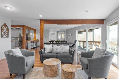 First floor living room with magnificent lake views and access to the back yard from the deck. Open floor concept.