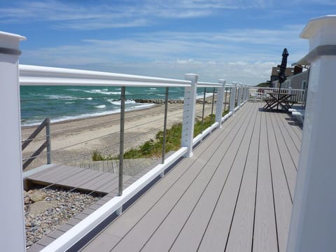 Relax on a wrap-around deck or walk onto the beach.