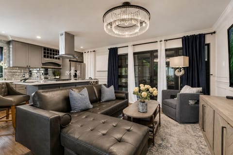 An open-concept living room with a leather sectional, ideal for entertaining.