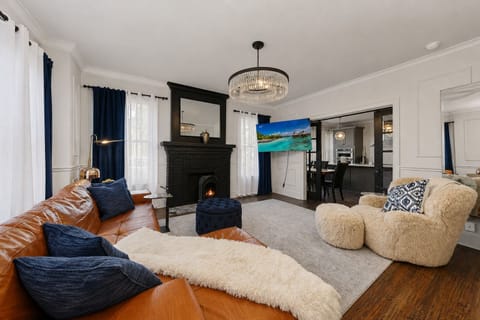 Relax in this bright and airy living room with brick stone fireplace. 