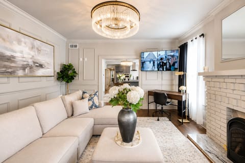 The living room is equipped with a crystal-clear Smart TV, perfect for cozying up and enjoying your favorite shows or a movie night by the fireplace. 