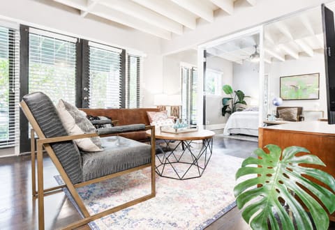 Front-Porch View – Living room windows overlook the charming tree-lined street of Munger Place.