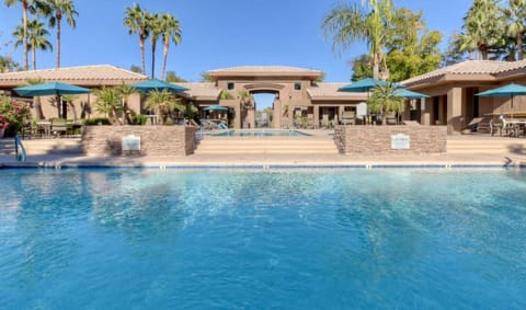 Two pools-one heated with  umbrella-shaded tables and chairs with clean grills. 