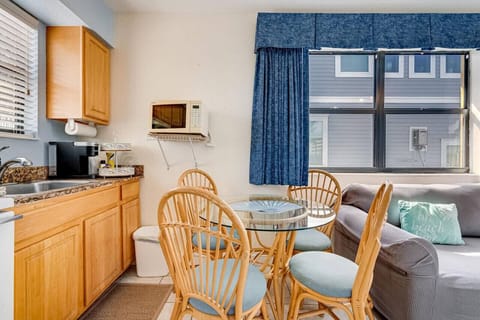 Open kitchen and dining nook w/ warm wood cabinets and a cozy table for easy meals.