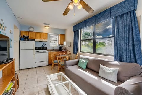 Open living space w/ sofa, dining table, and kitchen flowing together for easy stays