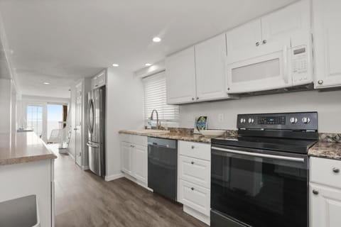full kitchen with stove, microwave, dishwasher and full size refridgerator