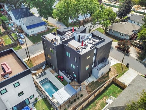 Stunning aerial shot of the private rooftop with city skyline views, 70” HDTV, fire pit, outdoor furniture seating, BBQ grill and bar. What more could you want?!