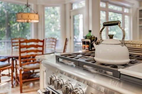 Our kitchen area is open concept with the living space and features a kitchen island, high-end amenities and appliances, a ton of built-in storage and direct access to the back porch.