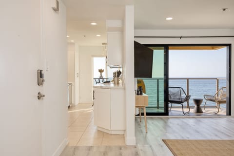 The kitchen is behind the living room.