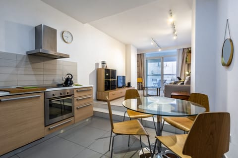 Spacious Living dining leading onto a balcony with side sea views.
