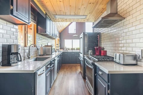 Upscale kitchen that's fully stocked.  Gas stove and 2 refrigerators for you!