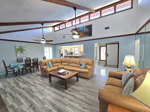 Large living room/dining room/kitchen in background/  high ceilings