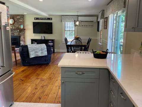 The kitchen is open to the dining and living area; slider opens to the deck.