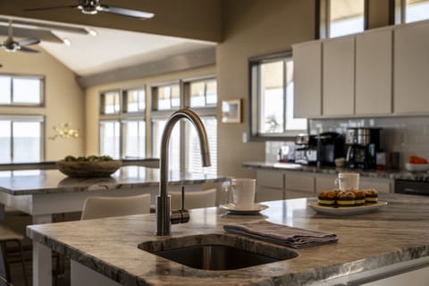 The spacious layout and high-end amenities make it the perfect space for hosting and enjoying meals with stunning ocean views.