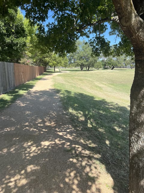Back gate opens on to greenbelt space with walking trail and park access