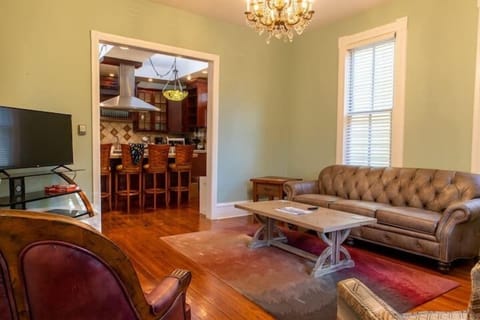 Spacious living room with plenty of seating and a large Smart TV.