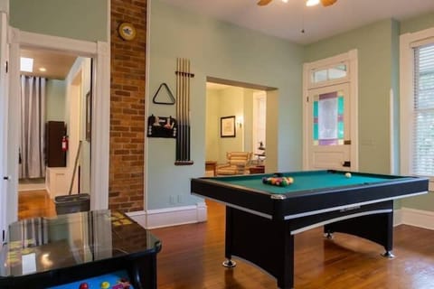 Incredible game room with a pool table, ping pong topper, and arcade machine!