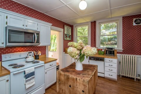 full kitchen fully stocked with cooking supplies.