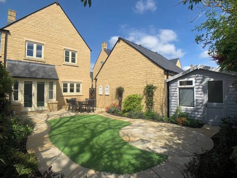 Sunny enclosed garden with large table and chairs to seat 8 guests. Summerhouse with sofa, PS4 and selection of games.