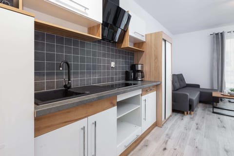 Kitchenette with plenty of kitchen utensils and dishes. 