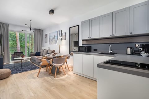 Kitchenette with plenty of kitchen utensils and dishes.