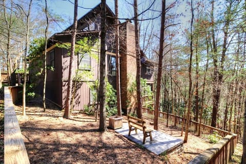 Fully fenced on side yard with hammock, firepit, and hanging lights