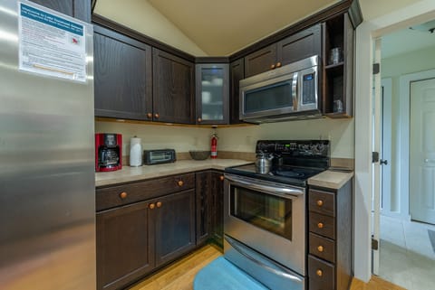 Kitchen complete with a dishwasher and standard drip coffeemaker.