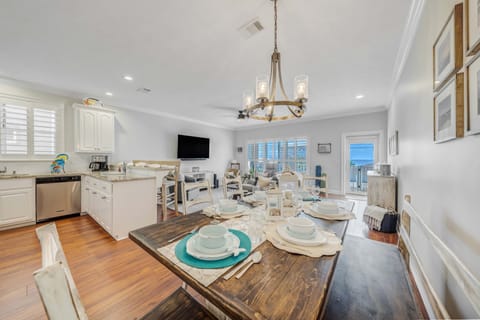 There is a dining table, perfect for enjoying a meal or playing a game, as well as additional breakfast bar seating.