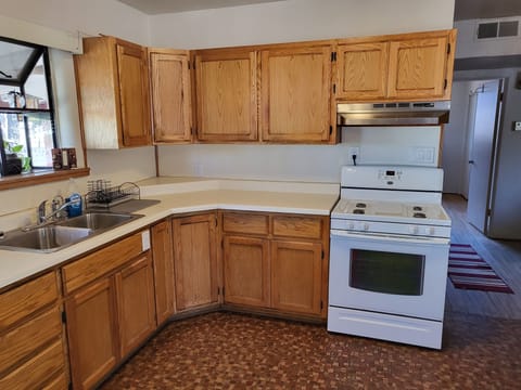 Kitchen closer with plenty of cabinet space, eating & cooking utensils & hallway