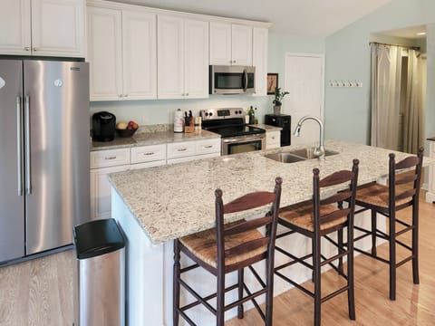 New stainless steel appliances and granite countertops in the island kitchen