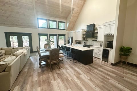 Bright open-concept living and dining area with soaring ceilings.