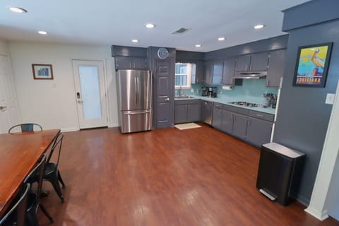 Glass door leading into carport/parking driveway and back fire pit