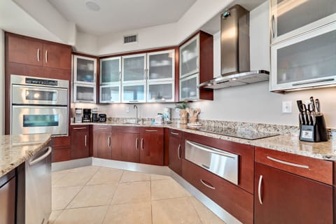 This well-designed kitchen boasts rich wood cabinetry, granite countertops, and stainless steel accents. The open layout ensures a seamless transition to the living and dining areas, creating a perfect space for gatherings.