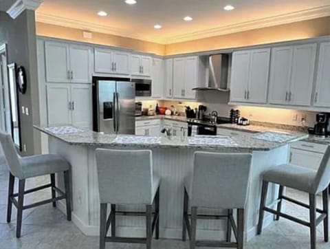 Kitchen area with island and chairs