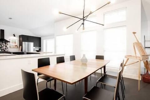 Stunning minimalist dining area with lots of seating perfect for gatherings