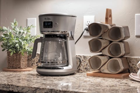 Start your morning right with freshly brewed coffee from your own Mr. Coffee maker, complete with mugs ready for your perfect cup.