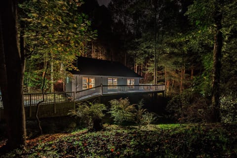 Pull up to your own cabin glowing in the trees at dusk — decks lit, woods quiet, your Smoky Mountain weekend officially begun.