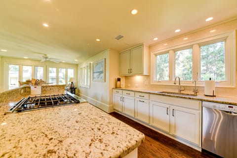 Open and spacious Chef's Kitchen comes equipped with high-end stainless-steel appliances, including a gas range, a second oven, and a microwave.