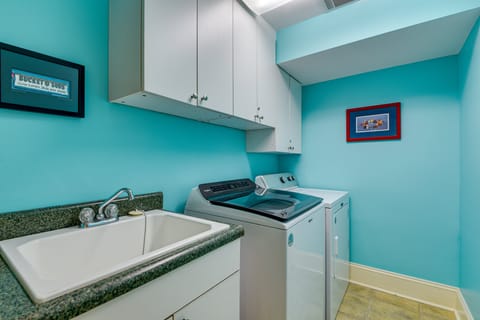 The first level houses a laundry room equipped with a full-size washer and dryer, along with an extra refrigerator for additional cold storage.