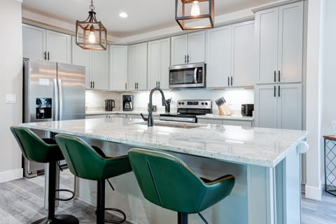 Modern kitchen with island seating, ideal for group meals or wine and snacks.