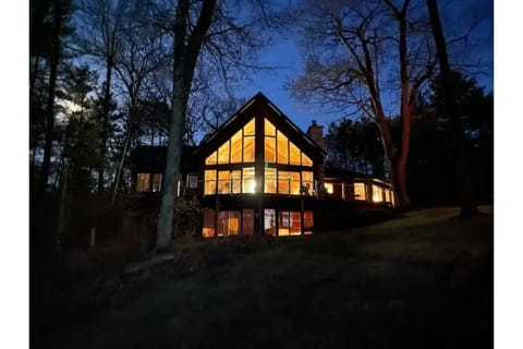 Exterior at night, looking up from the lake. 