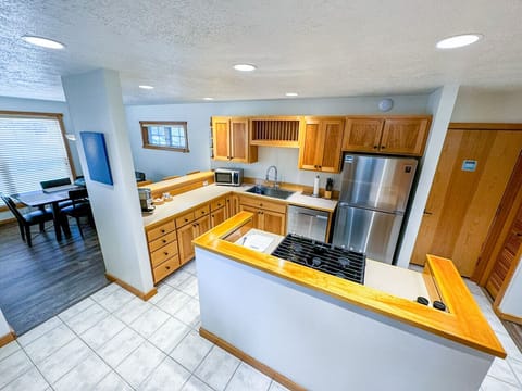 A fully equipped kitchen with modern appliances, ample counter space, and a cozy breakfast bar makes it easy to cook and entertain during your stay
