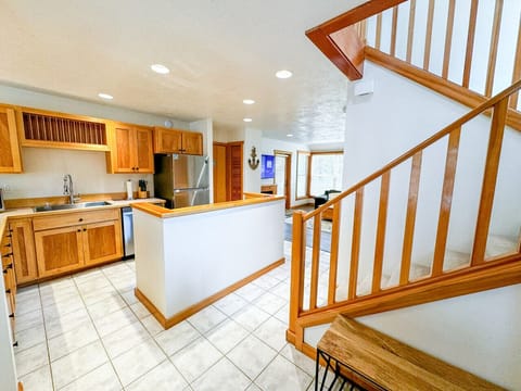 Make yourself at home in this spacious and well-appointed kitchen, complete with modern appliances and warm wooden cabinetry. The open layout flows seamlessly into the living and dining areas, creating a welcoming space for family meals and gatherings. Wi