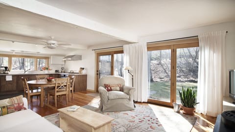 ...overlooking the stone patio, year-round stream + wooded conservation land.