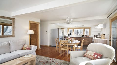 The open plan great room includes the kitchen, dining + lounge/TV areas