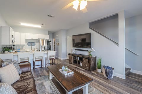 Living room looking into Kitchen area and access to the second floor. 