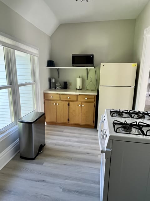 Kitchen with stove, Keurig, refrigerator, and microwave/air fryer.