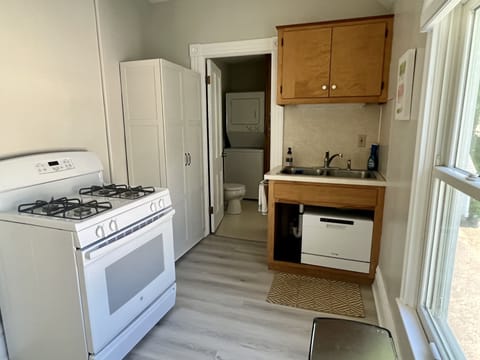 Kitchen with stove, dishwasher, pantry, refrigerator, and microwave/air fryer.