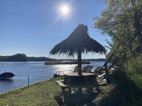 Private beach area complete with  beach loungers, SUP's, kayaks, paddle boat